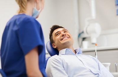 man-in-dental-chair-smiling-at-dentist